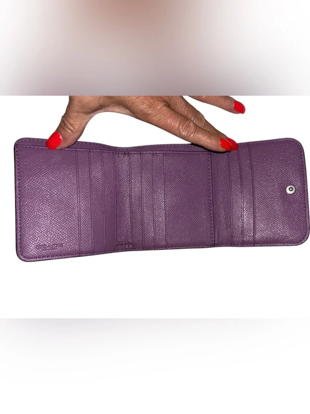 Coach Compact Trifold Pebbled Leather Wallet button closure in Plum/Purple.